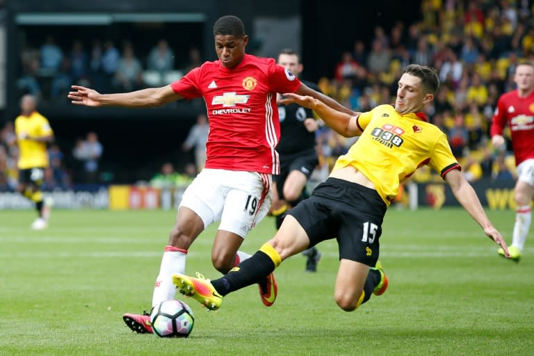 Manchester United's Marcus Rashford (left) is tackled by Watford's Craig Cathcart during their Premier League match at Vicarage Road Stadium in Watford, on September 18, 2016