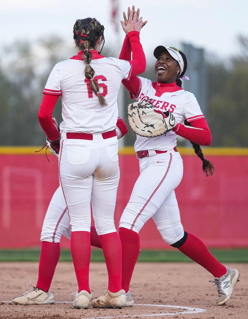 Fishers Tigers Taylor Duplessis (3) high-fives Fishers Tigers Kate Murray (16) on Tuesday, April 25, 2023 at Fishers High School in Fishers. The Fishers Tigers defeated the Hamilton Southeastern Royals, 1-0. 