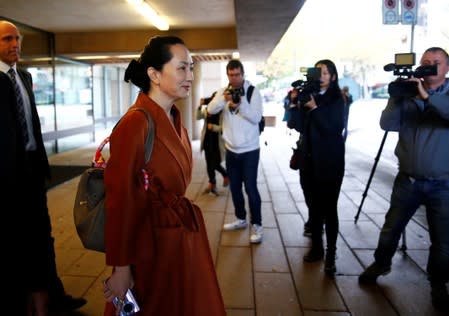 Huawei Technologies Chief Financial Officer Meng Wanzhou holds a Huawei cellphone as she leaves for a lunch break during a hearing at British Columbia supreme court in Vancouver