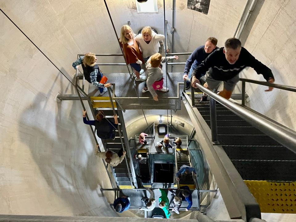 Visitors ascend the unusual "ships' ladder" stairs at Oak Island Lighthouse.