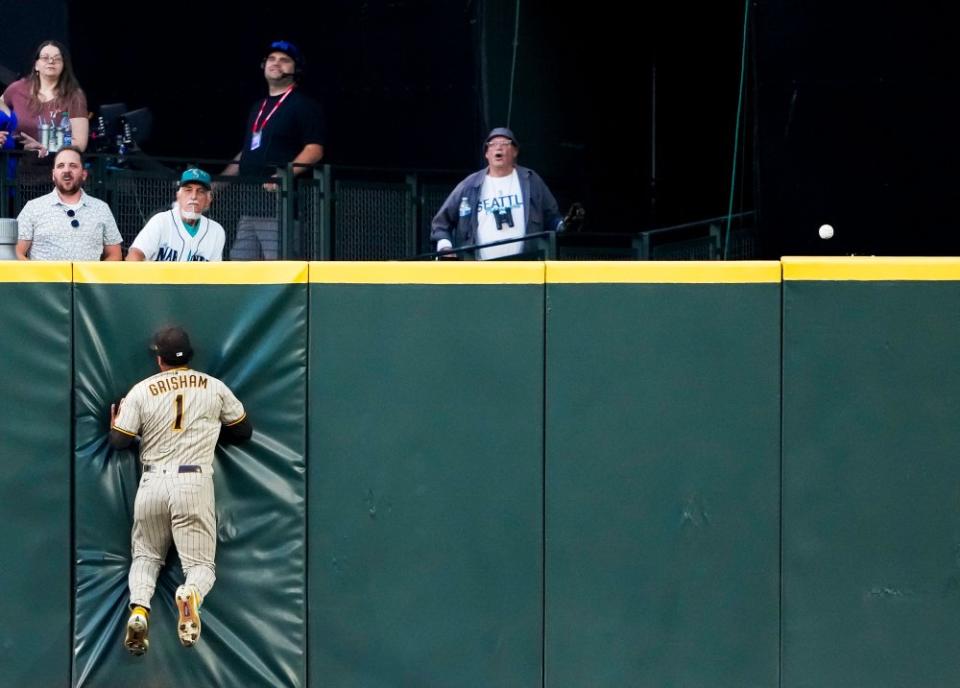 San Diego Padres center fielder Trent Grisham collides with the wall as the RBI triple from Seattle Mariners' Dylan Moore rolls along the top of the wall during the sixth inning of a baseball game in Seattle, on Aug. 8.<span class="copyright">Lindsey Wasson—AP</span>