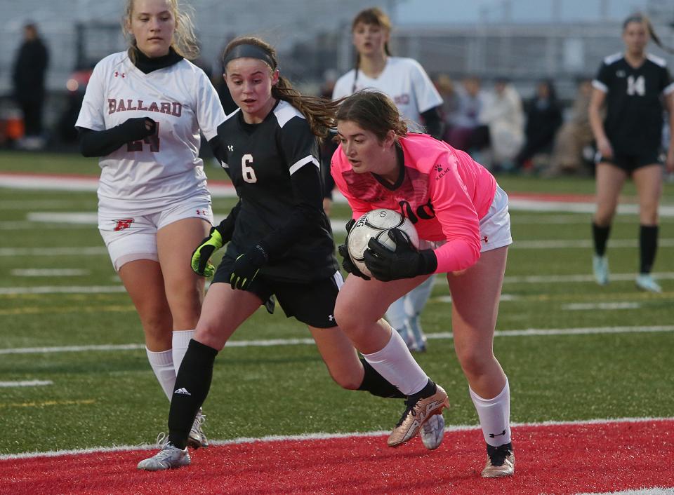 Ballard goalkeeper Maddie Catron (00) saves the ball in front of Gilbert forward Madisen Powers (6) during the first half of the Bombers' 8-0 loss to the Tigers at Gilbert High School Monday, April 3, 2023, in Gilbert, Iowa.