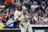 San Diego Padres designated hitter Fernando Tatis Jr. swings for a three-run home run during the ninth inning of a baseball game against the Houston Astros, Saturday, May 29, 2021, in Houston. (AP Photo/Michael Wyke)