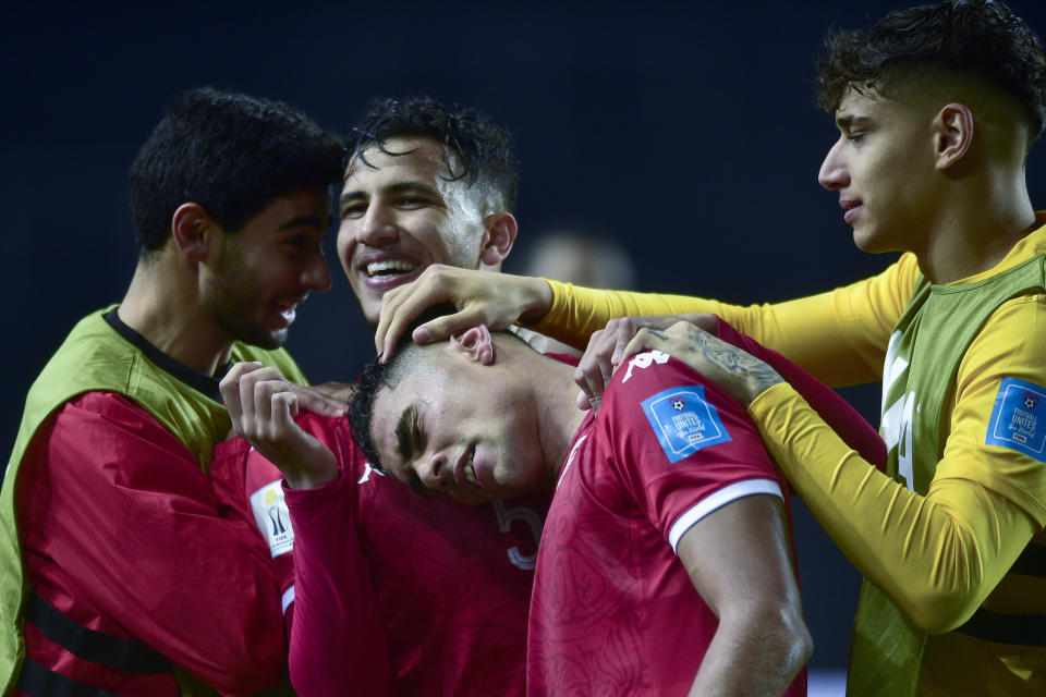 Tunisia's Youssef Snana, center, celebrates with his teammates after scoring his side's opening goal during a FIFA U-20 World Cup Group E soccer match against Iraq at Diego Maradona stadium in La Plata, Argentina, Thursday, May 25, 2023. (AP Photo/Gustavo Garello)