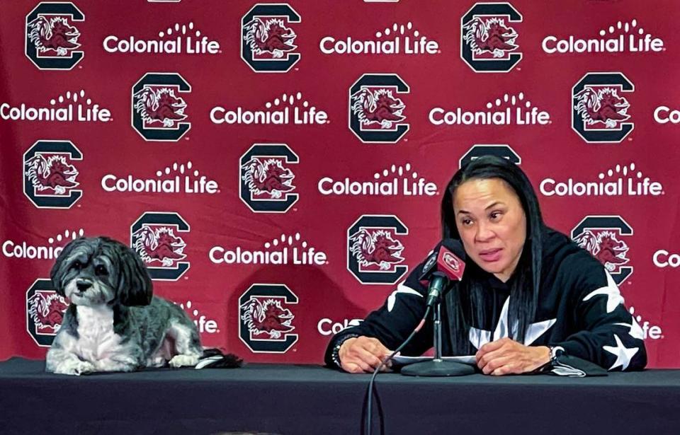 University of South Carolina Head Coach Dawn Staley answers questions during a press conference as her dog, Champ, sits by her side. Champ has accompanied Staley almost everywhere since she got him after winning he National Championship in 2017.