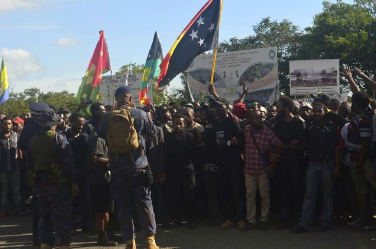 Police attempt to stop students as they start to march from the University of the Papua New Guinea in Port Moresby, on June 8, 2016