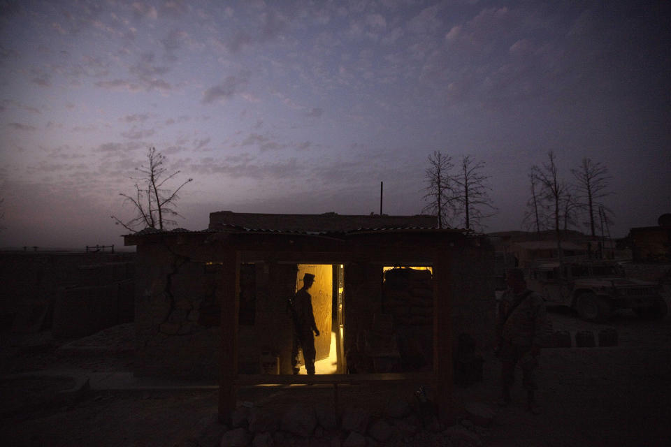 <p>U.S. Marine Lance Cpl. Matthew Timberlake, 20, of Roseville, Calif., with the 2nd Battalion 12th Marines based in Kaneohe Bay, Hawaii, stands in the doorway of his barrack on July 27, 2011 at Forward Operating Base Zeebrugge in Kajaki, Helmand province, Afghanistan. (AP Photo/David Goldman) </p>