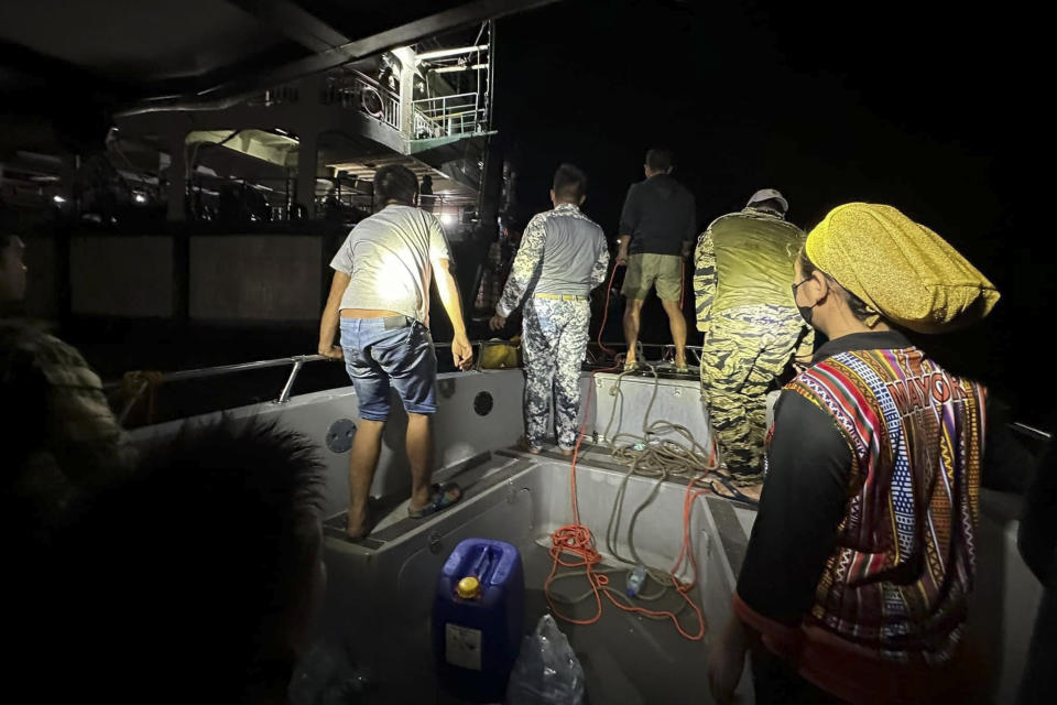 In this photo provided by the Philippine Coast Guard, Philippine Coast Guard personnel search for survivors from the fire on MV Lady Mary Joy at Basilan, southern Philippines early Thursday March 30, 2023. More than a dozen people died while other were reported missing after an inter-island cargo and passenger ferry with about 200 passengers and crew onboard caught fire close to midnight in the southern Philippines, a provincial governor said Thursday. (Philippine Coast Guard via AP)