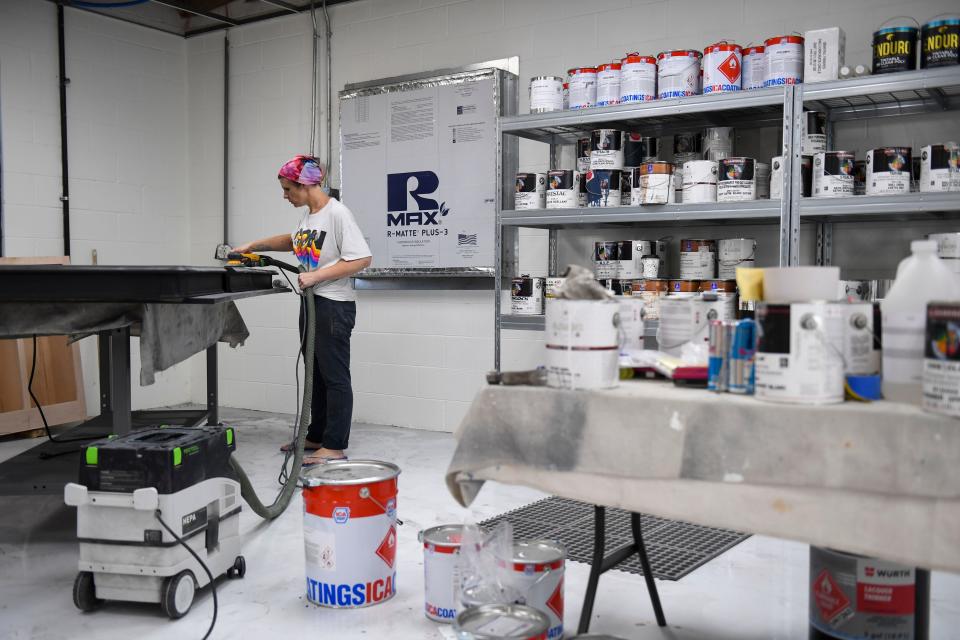 Holly Callaway, 35, works at her cabinetry job in Greenville, S.C., on July 31, 2023. Callaway juggles many jobs to provide for her family.