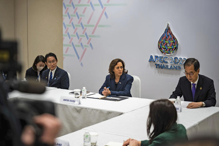 Kamala Harris sits, socially distanced, at a table with other leaders in front of a sign that reads: APEC 2022 Thailand.