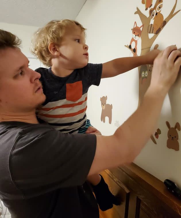 The writer's husband and oldest son decorate the nursery prior to the arrival of the unborn baby. (Photo: Courtesy of Gillan Ritchie)