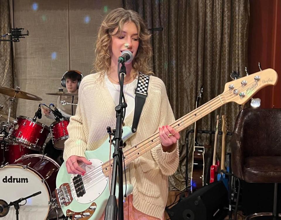 Arriana Kefalas plays bass and sings during a rehearsal with the pop rock band COMPASS. The Jackson Township group includes her brothers Harrison and Johnny. COMPASS will perform on Feb. 3 in the 27th annual Tri-C High School Rock Off at the Rock & Roll Hall of Fame in Cleveland.