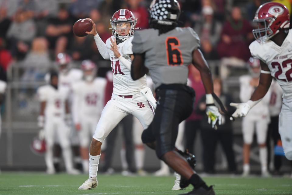 Oak Ridge’s Ethan Garza (14) throws a pass during a game between Powell and Oak Ridge at Powell, Friday, Sept. 30, 2022.