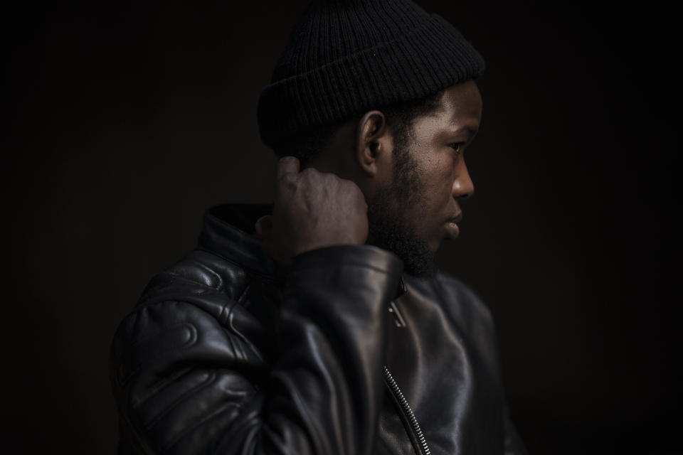 Moussa Sako, an asylum-seeker from Mali who survived 22 days aboard a Mauritanian boat drifting in the Atlantic Ocean, sits for an interview in Guadalajara, Spain, Sunday, Nov. 14, 2021. Sako was rescued by the Spanish Air Force on April 26, 2021. His boat was spotted by chance more than 310 miles (500 km) from the Spanish island of El Hierro — “in the middle of nowhere,” as one of the rescuers described it. They had set off 22 days earlier from Nouakchott, the capital of Mauritania. Only three of 63 people who boarded survived. (AP Photo/Felipe Dana)