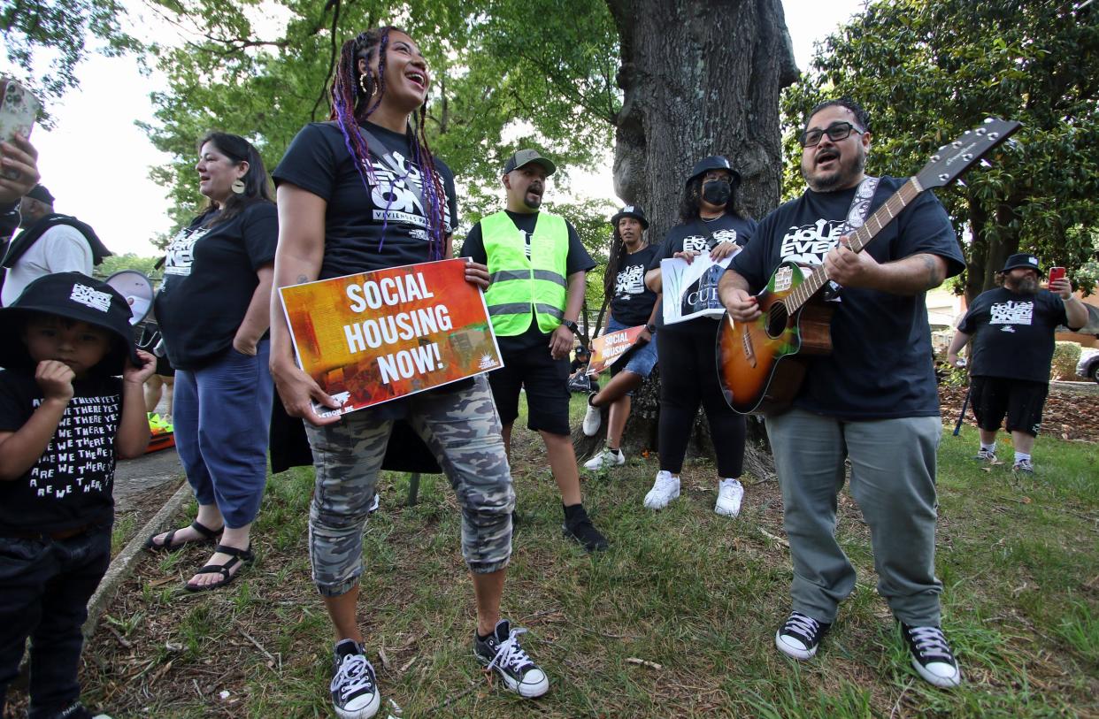 Dominique Medina, right, sings a protest song as a group gathers to protest in front of Charlotte Hill Mobile Home Park in Charlotte Monday afternoon, June 10, 2024.