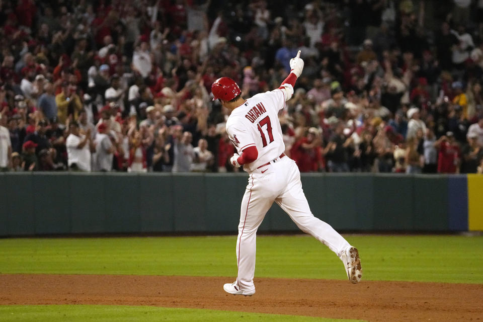 Los Angeles Angels' Shohei Ohtani celebrates as he heads to third after hitting a solo home run during the seventh inning of a baseball game against the Chicago White Sox Tuesday, June 27, 2023, in Anaheim, Calif. (AP Photo/Mark J. Terrill)