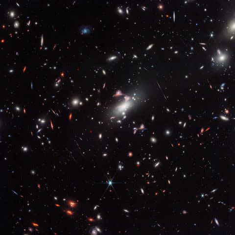 <p>webbtelescope</p> A cosmic question mark appears amid a powerful gravitational lens in the James Webb Space Telescope’s wide-field view of the galaxy cluster MACS-J0417.5-1154