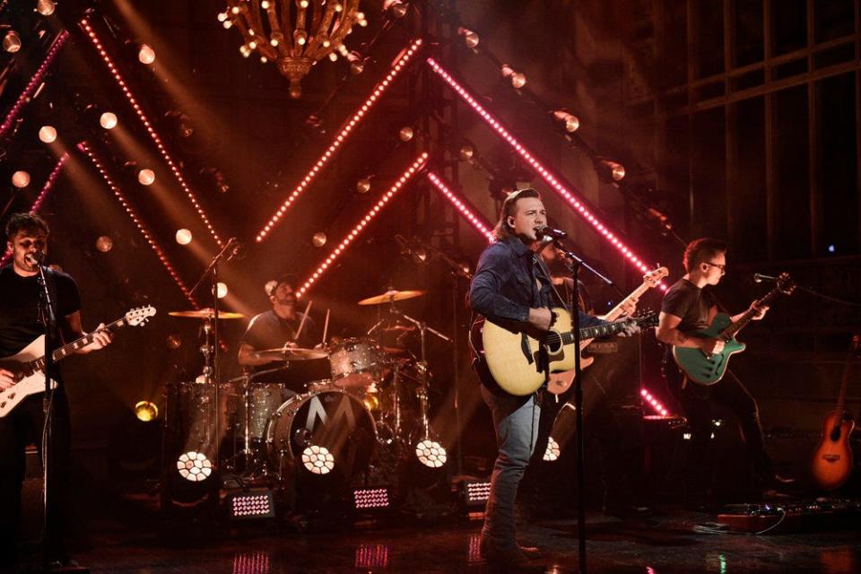 Country music singer Morgan Wallen served as musical guest two months after he was held from making his "SNL" debut because videos on social media captured him partying with strangers without a mask.