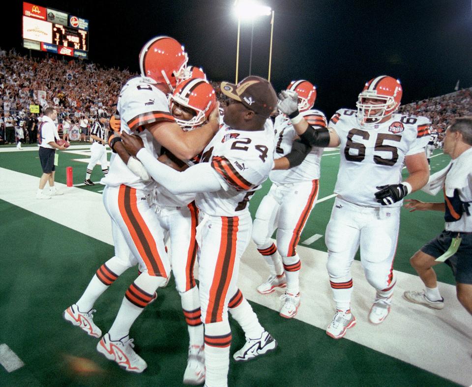 Tim Couch (left) hugs a receiver after a touchdown. The Cleveland Browns defeated the Dallas Cowboys 20-17 in the Pro Football Hall of Fame Game on Aug. 9, 1999.