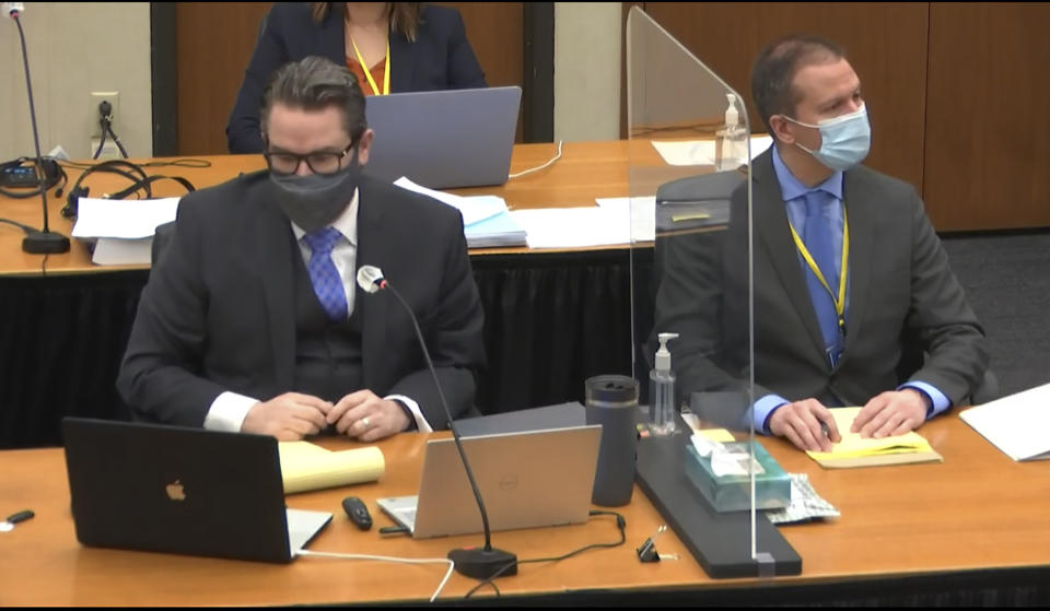 In this image from video, defense attorney Eric Nelson, left, defendant, former Minneapolis police officer Derek Chauvin, right, listen, Wednesday, April 14, 2021, as Hennepin County Judge Peter Cahill presides over motions in the trial of Chauvin at the Hennepin County Courthouse in Minneapolis. Chauvin is charged in the May 25, 2020 death of George Floyd. (Court TV, via AP, Pool)