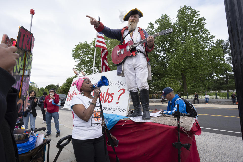 Activists from opposing political positions demonstrate outside the Supreme Court as the justices hear arguments over whether Donald Trump is immune from prosecution in a case charging him with plotting to overturn the results of the 2020 presidential election, on Capitol Hill in Washington, Thursday, April 25, 2024. (AP Photo/J. Scott Applewhite)