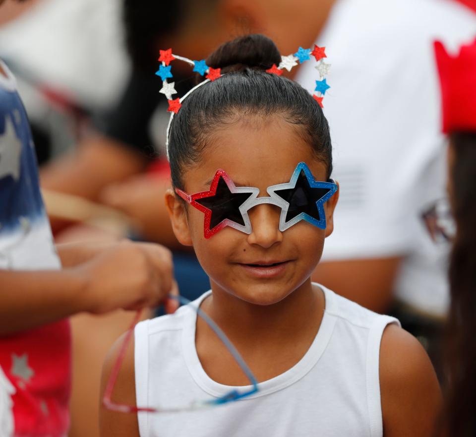 Nine-year-old Daisy Zuniga watches the parade at the 31st annual 4th on Broadway Independence Day parade and festival Saturday, July 3rd, 2021. (Mark Rogers/For A-J Media)