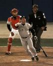 FILE - In this Oct. 23, 1996, file photo, New York Yankees Jim Leyritz watches his eighth inning three-run home run with Atlanta Braves catcher Eddie Perez and plate umpire Steve Rippley during Game 4 of baseball's World Series in Atlanta. As the World Series comes to Atlanta for the first time since 1999, there is hope that the city — once immortalized by Sports Illustrated as “Loserville” — and the entire state of Georgia, for that matter, could be taking a turn toward some long-overdue parades and celebrations. (AP Photo/Ron Frehm, File)