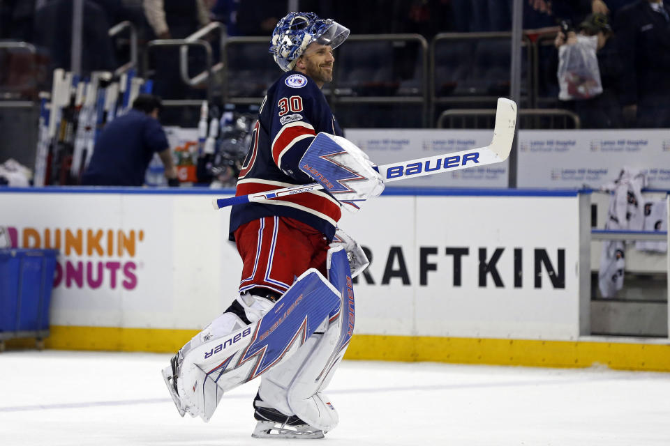 FILE - In this Feb. 11, 2017, file photo, New York Rangers goalie Henrik Lundqvist celebrates his 400th career win, after an NHL hockey game against the Colorado Avalanche, in New York. The Rangers won 4-2. The New York Rangers have bought out the contract of star goaltender Henrik Lundqvist. The Rangers parted with one of the greatest netminders in franchise history on Wednesday, Sept. 30, 2020, when they paid off the final year of his contract. (AP Photo/Adam Hunger, File)