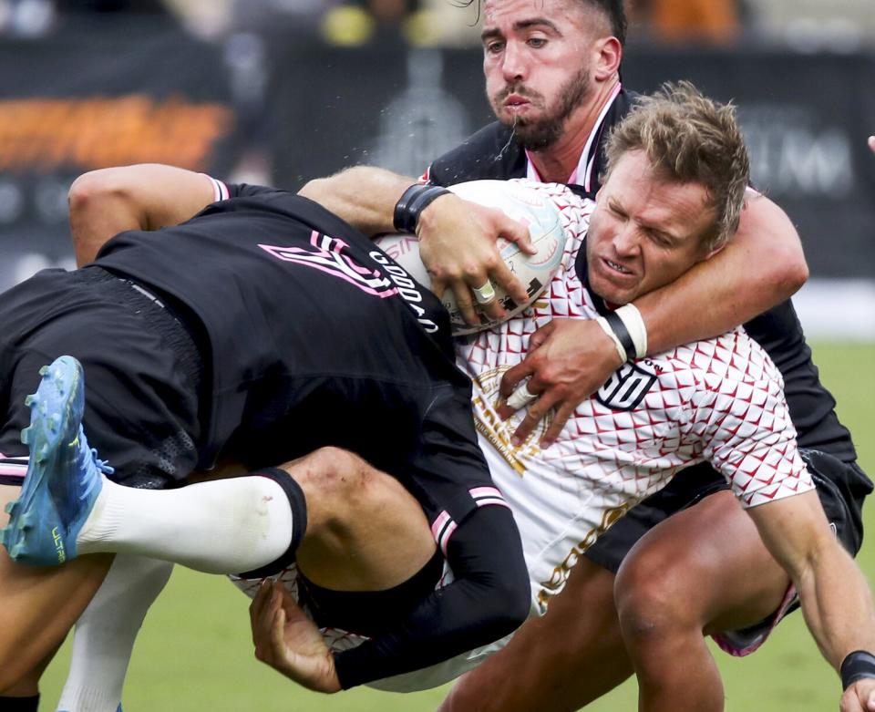 Los Angeles Giltinis players Harrison Goddard (9) and Luke Burton bring down the San Diego Legion's Will Hooley.