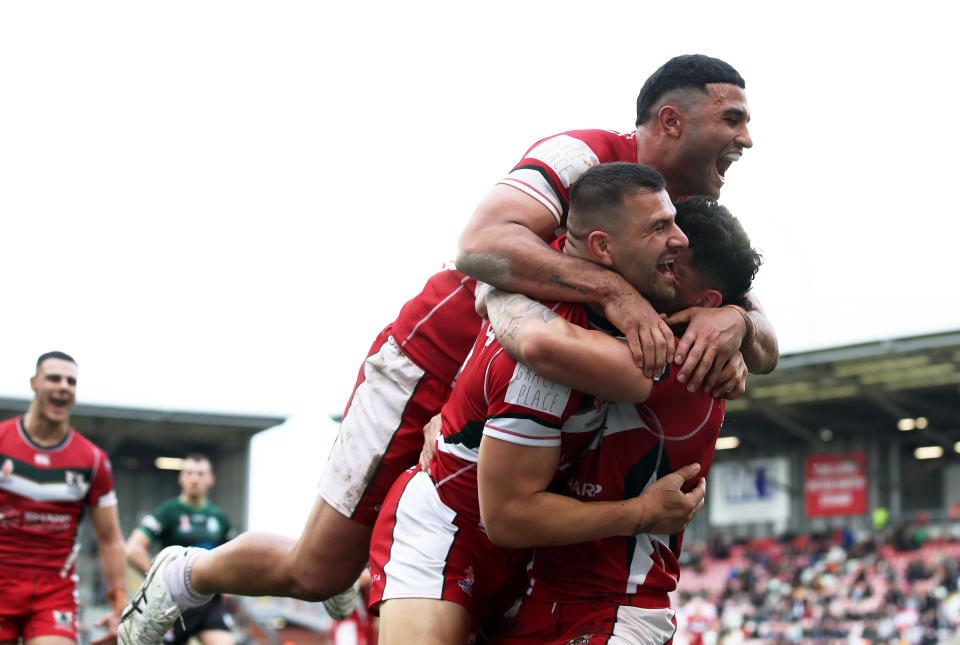 Brandon Morkos celebrates with his teammates after a try.