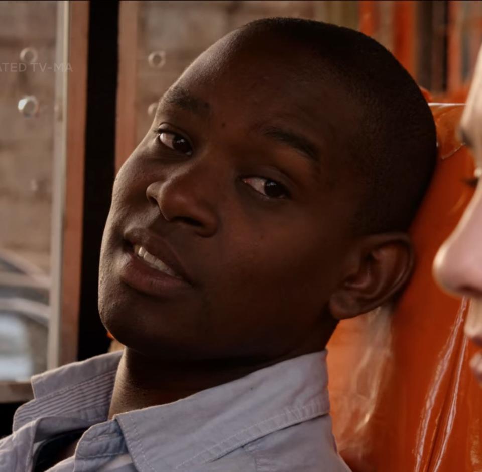 Aml Ameen as Capheus sits in a bus and comforts Riley in "Sense8"