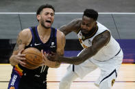 Phoenix Suns forward Abdel Nader (11) is fouled by Denver Nuggets forward JaMychal Green during the second half of an NBA basketball game Saturday, Jan. 23, 2021, in Phoenix. (AP Photo/Rick Scuteri)