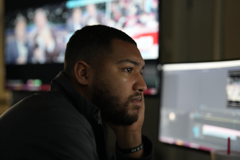 Jaden, a host and production assistant, works at Right Side Broadcasting Network in Opelika, Ala., as Republican presidential candidate former President Donald Trump speaks at a campaign rally in North Carolina on Saturday, March 2, 2024. (AP Photo/Mike Stewart)