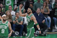 Boston Celtics forward Jayson Tatum, center, celebrates during the first half of Game 7 against the Philadelphia 76ers in the NBA basketball Eastern Conference semifinal playoff series, Sunday, May 14, 2023, in Boston. (AP Photo/Steven Senne)