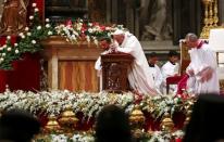 Pope Francis kneels as he leads the Christmas night Mass in Saint Peter's Basilica at the Vatican December 24, 2016. REUTERS/Tony Gentile