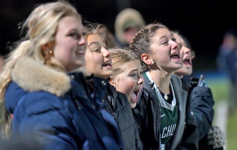 Players along the Wachusett sideline shout encouragement as the clock winds down.