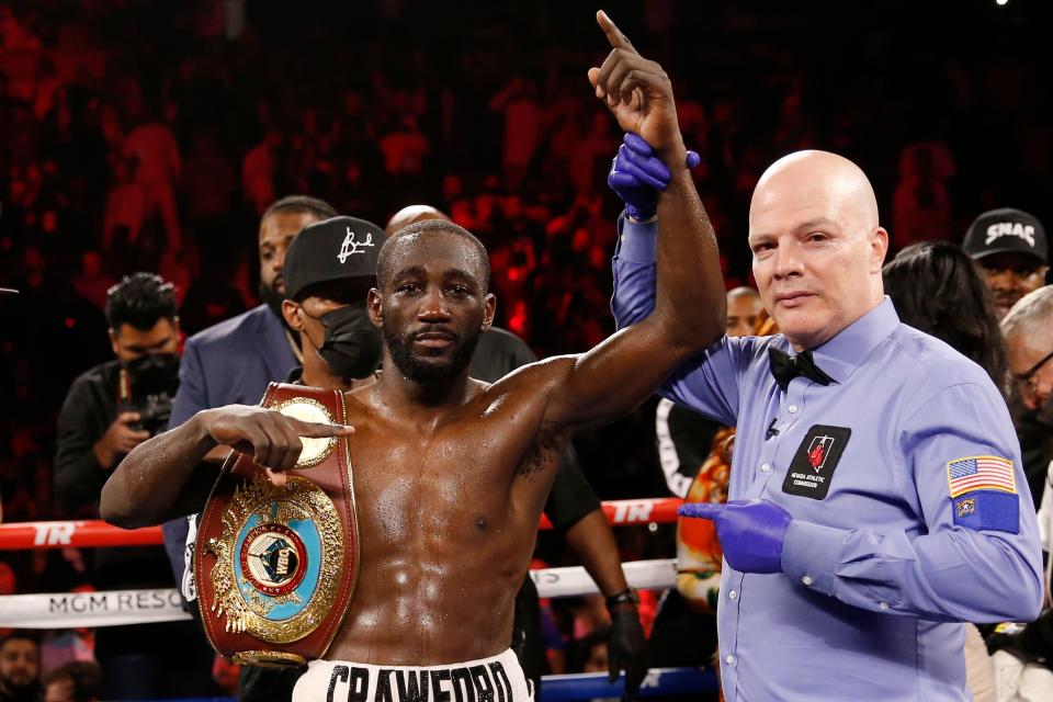 Terence Crawford poses for photographers after defeating Shawn Porter by TKO in a welterweight title boxing match, Nov. 20, 2021, in Las Vegas. The stage was then set for him to finally get in the ring with Errol Spence Jr., but the fight never materialized for a variety of reasons that have become common in boxing today.