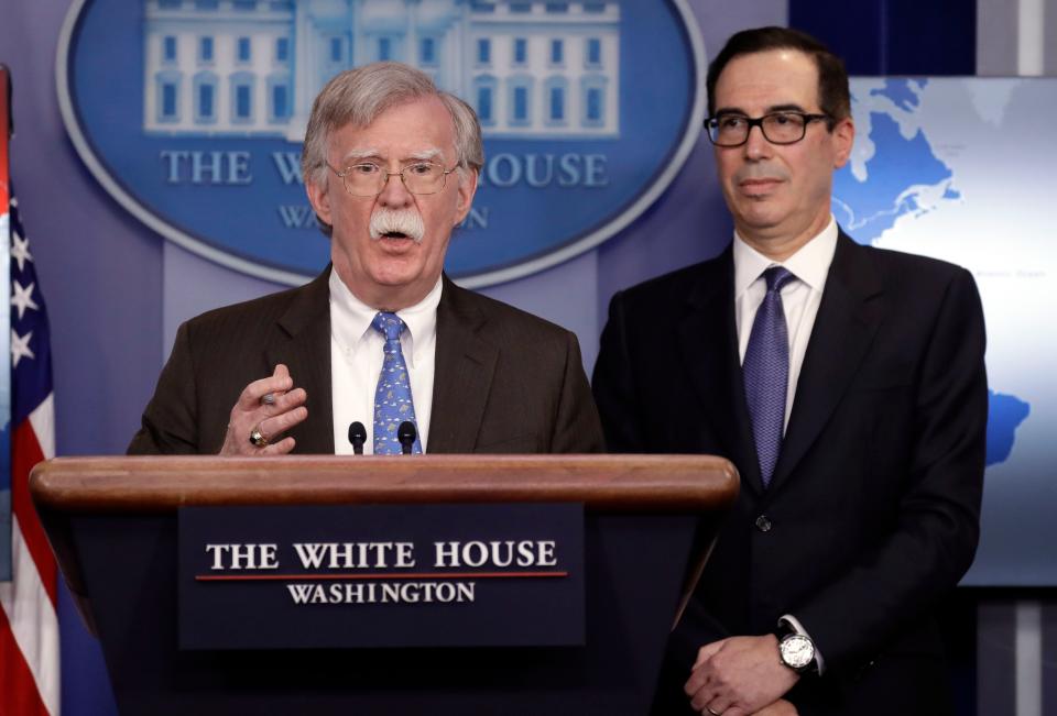 National security adviser John Bolton speaks as Treasury Secretary Steven Mnuchin listens during a press briefing at the White House, Monday, Jan. 28, 2019, in Washington.