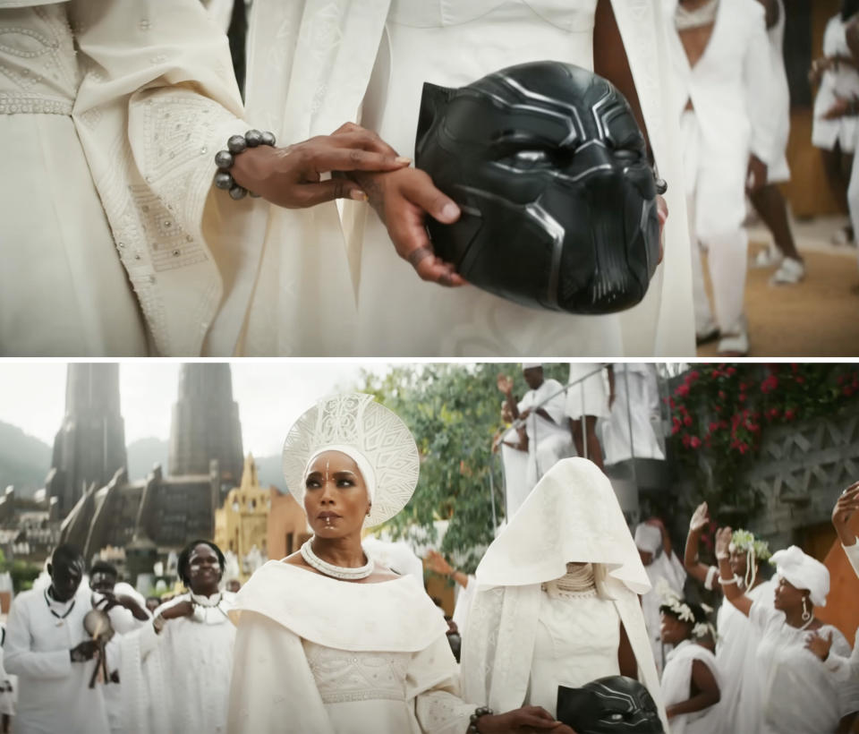 Queen Ramonda walks with the funeral procession for T'Challa alongside her daughter Shuri who's holding the Black Panther mask