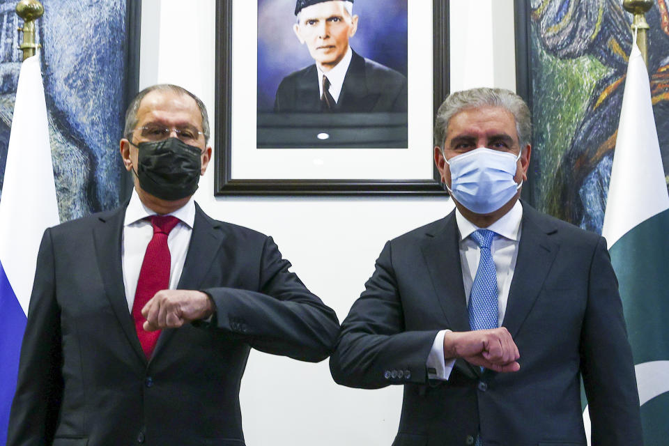 In this handout photo released by Russian Foreign Ministry Press Service, Russian Foreign Minister Sergey Lavrov, left, and Pakistani Foreign Minister Shah Mahmood Qureshi pose for a photo prior to their talks in Islamabad, Pakistan, Wednesday, April 7, 2021. (Russian Foreign Ministry Press Service via AP)