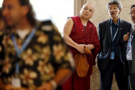 Former political prisoner Tibetan monk Golog Jigme (C) attends a side event at the U.N. Human Rights Council in Geneva, Switzerland in this June 15, 2015 file photo. REUTERS/Pierre Albouy/Files