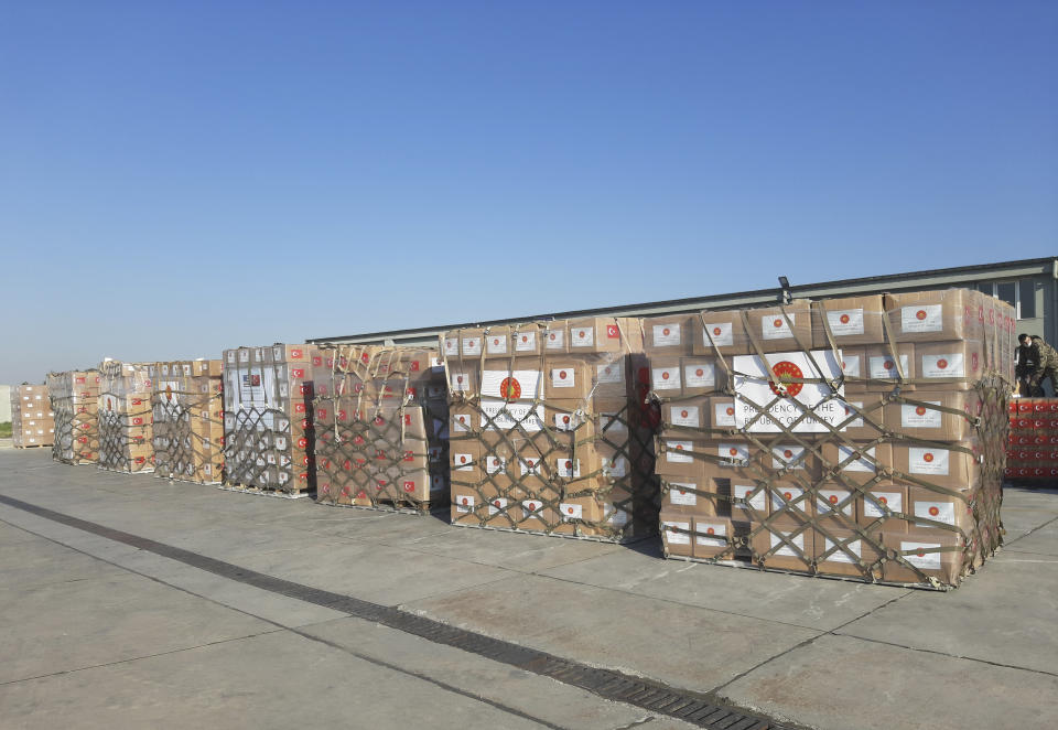 In this handout photo provided by the Turkish Defense Ministry, Turkish soldiers prepare to load a military cargo plane with Personal Protection Equipment donated by Turkey to help United States combat the new coronavirus outbreak, at the Etimesgut airport outside Ankara, Turkey, Tuesday, April 28, 2020. Turkey is sending a planeload of surgical masks, N95 masks and hazmat suits to U.S. to help the country battle the coronavirus outbreak.(Turkish Defence Ministry via AP)