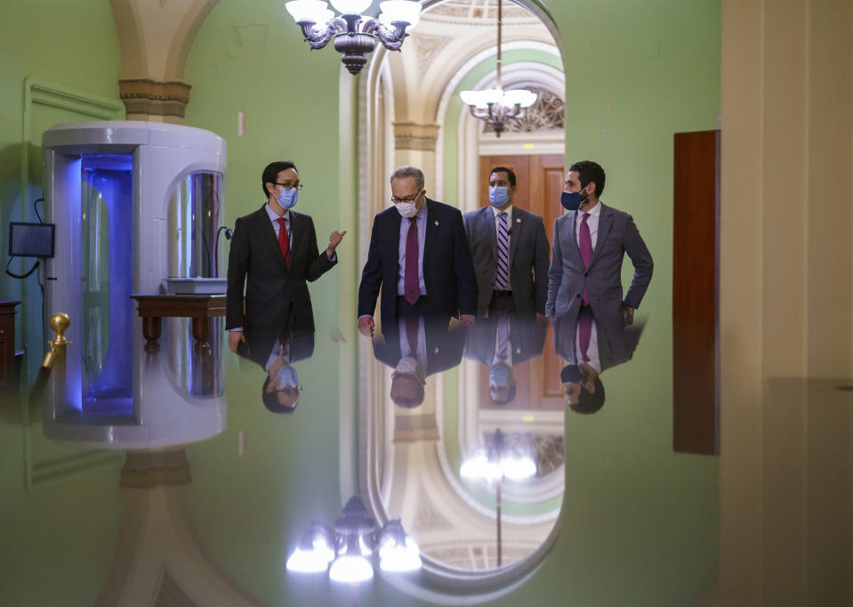 Senate Majority Leader Chuck Schumer, D-N.Y., walks with his staff just after the Senate narrowly approved a $1.9 trillion COVID-19 relief bill, at the Capitol in Washington, Saturday, March 6, 2021. Senate passage sets up final congressional approval by the House next week so lawmakers can send it to President Joe Biden for his signature. (AP Photo/J. Scott Applewhite)