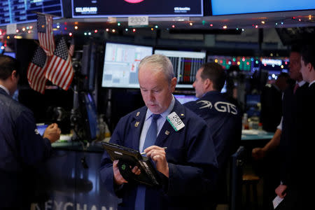 FILE PHOTO: A trader works on the floor at the New York Stock Exchange (NYSE) in New York City, New York, U.S., January 2, 2019. REUTERS/Shannon Stapleton