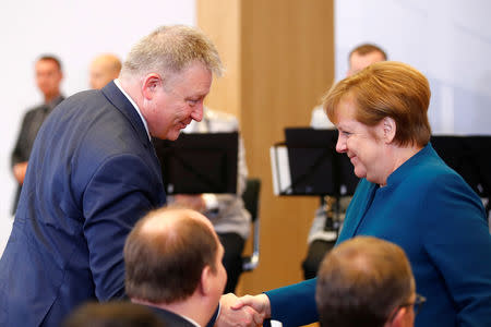 German Chancellor Angela Merkel shakes hands with the President of the German Federal Intelligence Agency (BND) Bruno Kahl, during the opening ceremony of the new BND (Federal Intelligence Service) headquarter in Berlin, Germany, February 8, 2019. REUTERS/Axel Schmidt