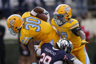 Southern University running back Braelen Morgan (30) is tackled by Jackson State defensive back Delano Salgado (29) during the first half of the Southwestern Athletic Conference championship NCAA college football game Saturday, Dec. 3, 2022, in Jackson, Miss. (AP Photo/Rogelio V. Solis)