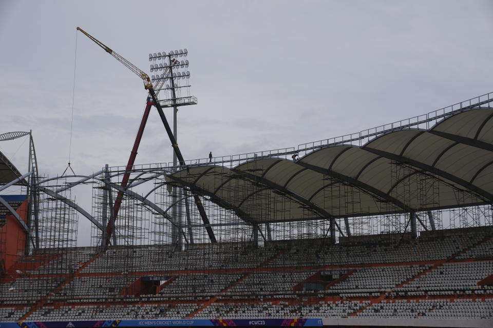 Laborers work inside the Rajiv Gandhi International Cricket Stadium which is getting ready for the upcoming ICC Men's Cricket World Cup in Hyderabad, India, Thursday, Sept. 21, 2023. (AP Photo/Mahesh Kumar A.)