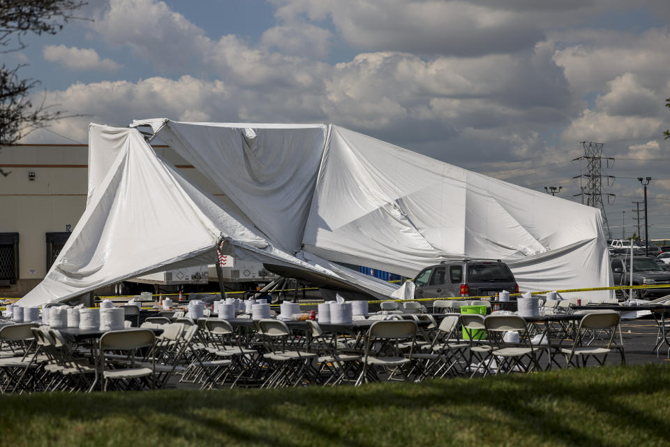 A collapsed tent sits in a parking lot in the 5600 block of West 73rd Street Thursday, Sept. 14, 2023 in Bedford Park, Chicago. Police say a number of people were injured. (Armando L. Sanchez/Chicago Tribune via AP)