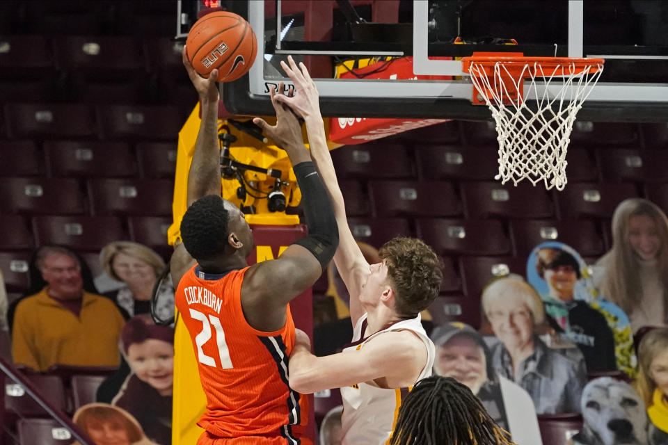 Illinois' Kofi Cockburn (21) shoots over Minnesota's Liam Robbins (0) in the first half of an NCAA college basketball game, Saturday, Feb. 20, 2021, in Minneapolis. (AP Photo/Jim Mone)