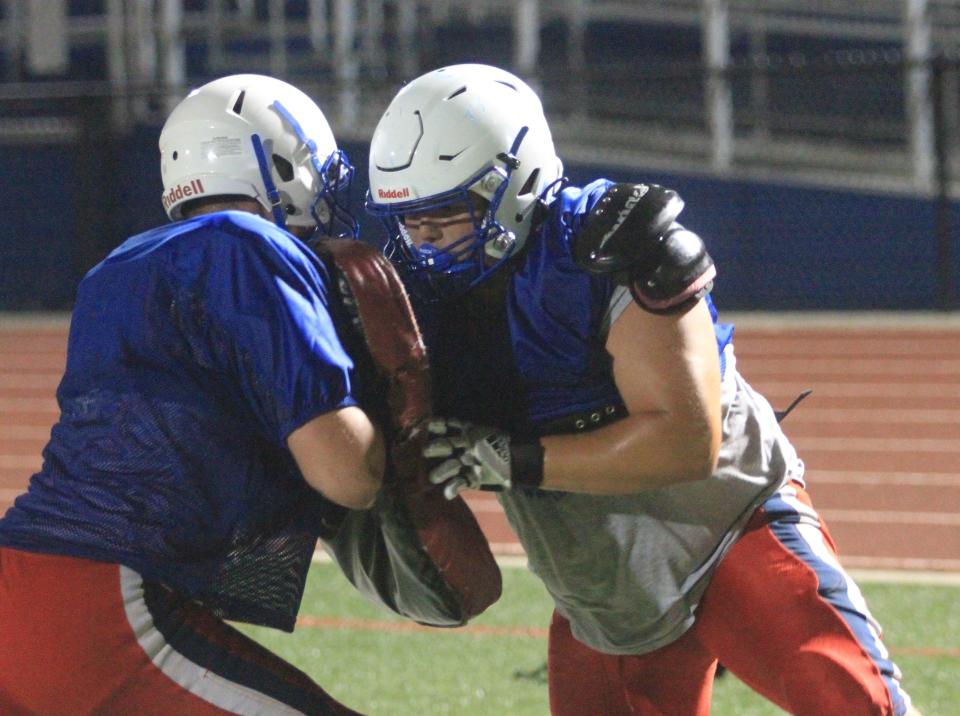 Lakewood's Keegan Jacks, right, participates in a blocking drill with Brayden Shull during Midnight Madness at Calhoun Memorial Field on Monday, July 31, 2023.